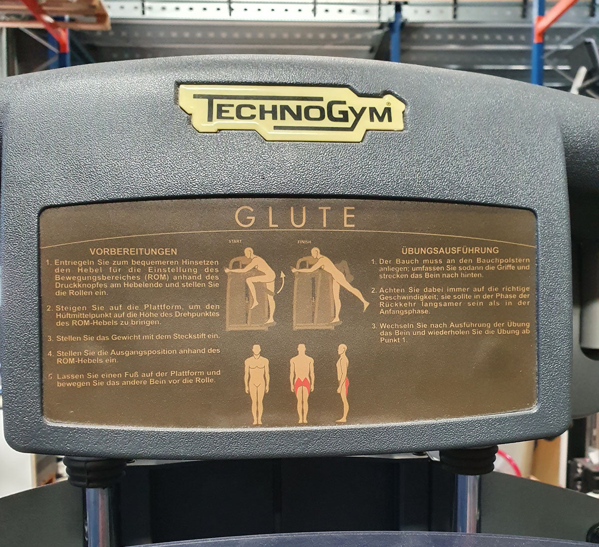 TechnoGym Gluteus Machine, Glute, Selection Line - New model with plastic cover, brown upholstery, used - refurbished condition