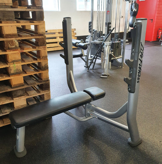 Life Fitness Flat Press Bench, Olympic Flat Bench SOFB, Signature Series, frame color silver, upholstery color black, used - refurbished condition