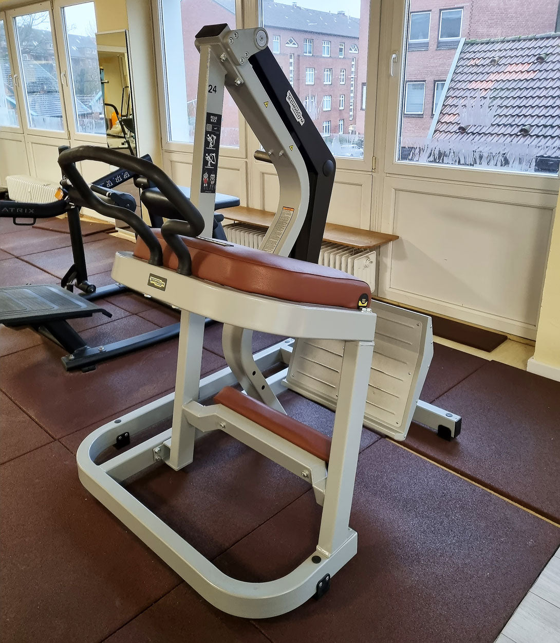 Technogym Pure Rear Kick, gluteus machine, butt machine standing, glute, plate loaded, Pure Strength Series disc holder, frame color silver, used - refurbished condition