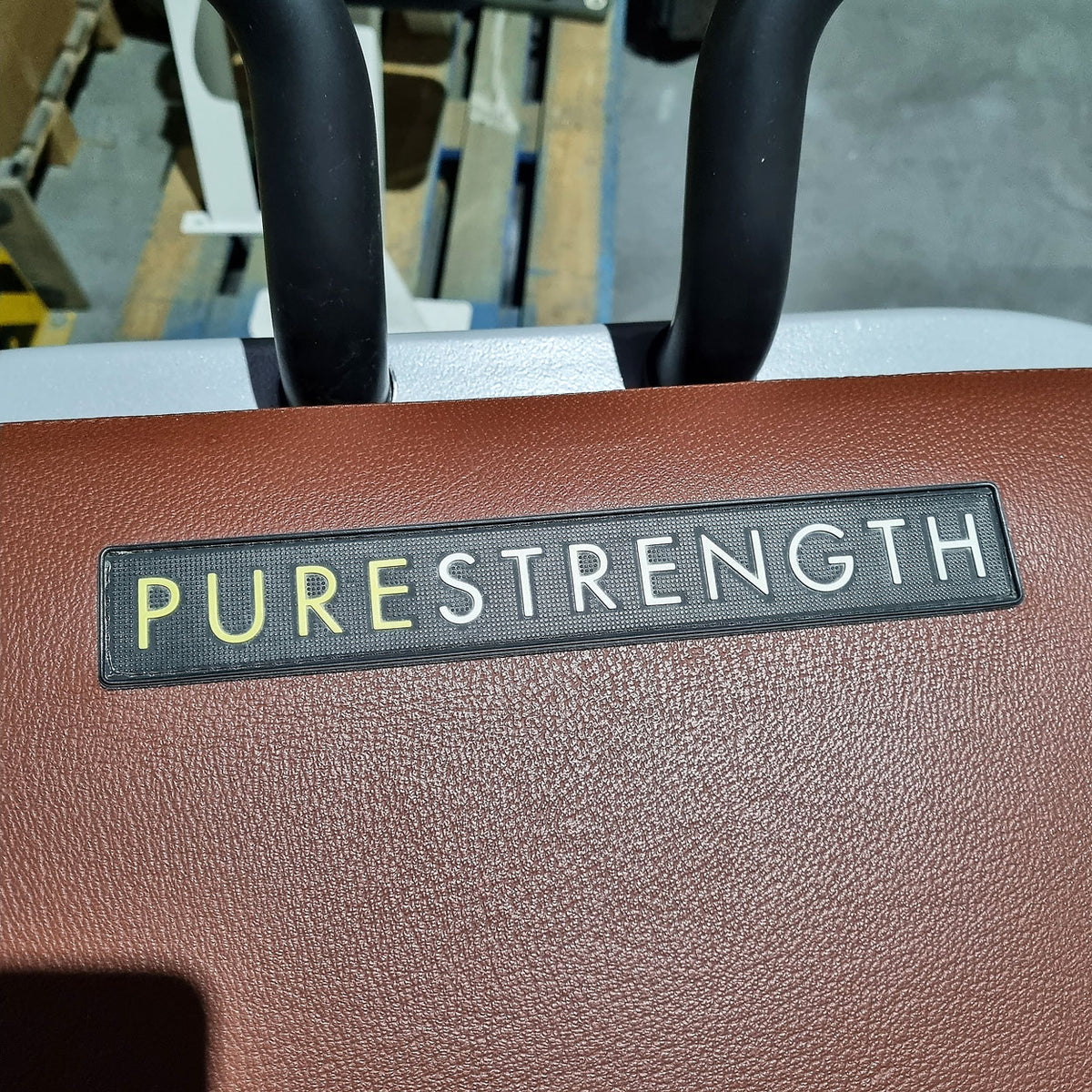 Technogym Pure Rear Kick, gluteus machine, butt machine standing, glute, plate loaded, Pure Strength Series disc holder, frame color silver, used - refurbished condition