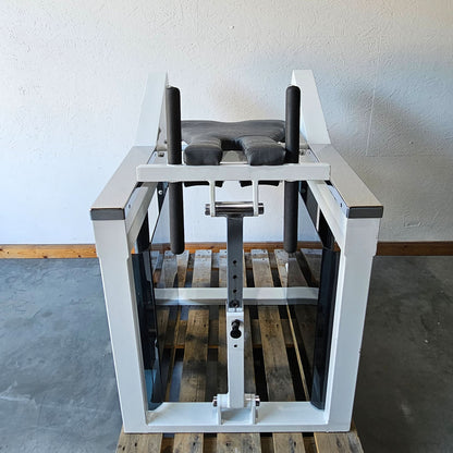 Bruns buttock machine, standing glute machine, glute isolator raise, old school bodybuilding strength machine, white frame, used with signs of wear