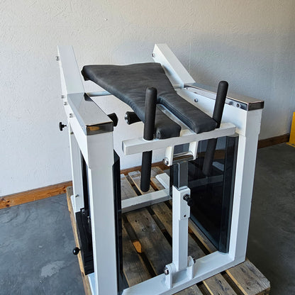 Bruns buttock machine, standing glute machine, glute isolator raise, old school bodybuilding strength machine, white frame, used with signs of wear