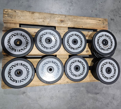 Technogym various weight plates, 230 kg total, 28 mm diameter, cast with rubber outer, 2.5 kg - 5 kg - 10 kg and 20 kg plates, used with signs of wear