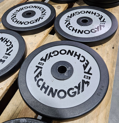 Technogym various weight plates, 230 kg total, 28 mm diameter, cast with rubber outer, 2.5 kg - 5 kg - 10 kg and 20 kg plates, used with signs of wear