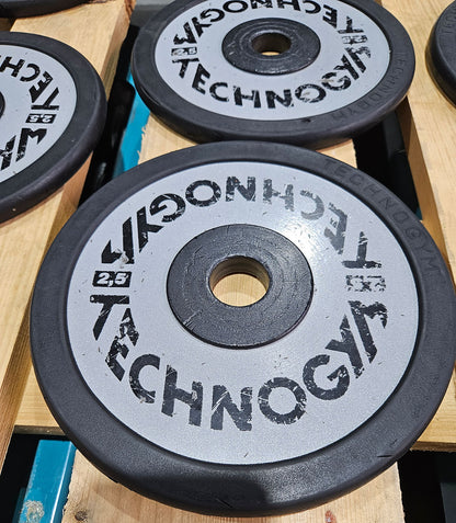 Technogym various weight plates, 230 kg total, 28 mm diameter, cast with rubber outer, 2.5 kg - 5 kg - 10 kg and 20 kg plates, used with signs of wear