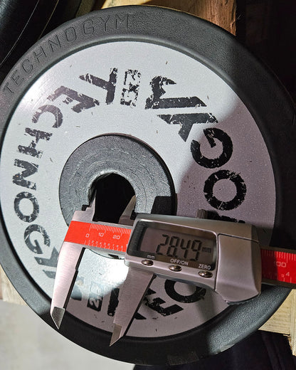 Technogym various weight plates, 230 kg total, 28 mm diameter, cast with rubber outer, 2.5 kg - 5 kg - 10 kg and 20 kg plates, used with signs of wear
